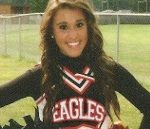 Smiling young woman in an Eagles cheerleader uniform
